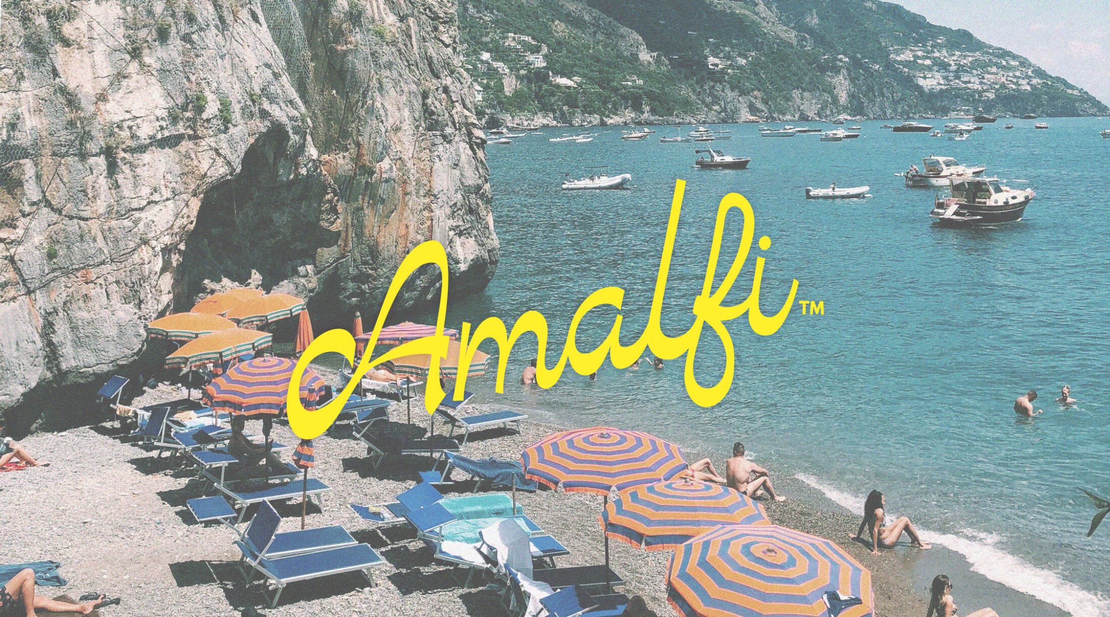 Yellow script Amalfi logo over a vintage style photo of the Amalfi coast with the iconic striped umbrellas and cool blue ocean.